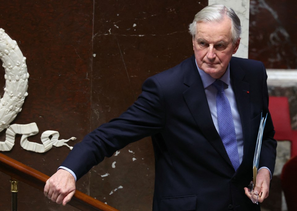 Barnier leaves after delivering a speech during the debate prior to the no-confidence votes