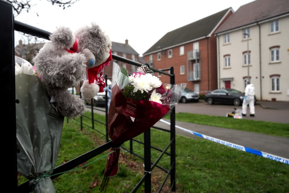 Floral tributes outside a police cordon in Santa Cruz Avenue, near Bletchley, Buckinghamshire