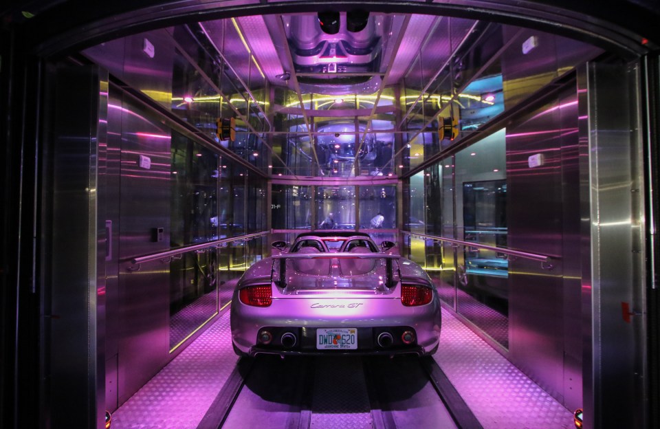 Porsche Carrera GT in a glass car elevator.