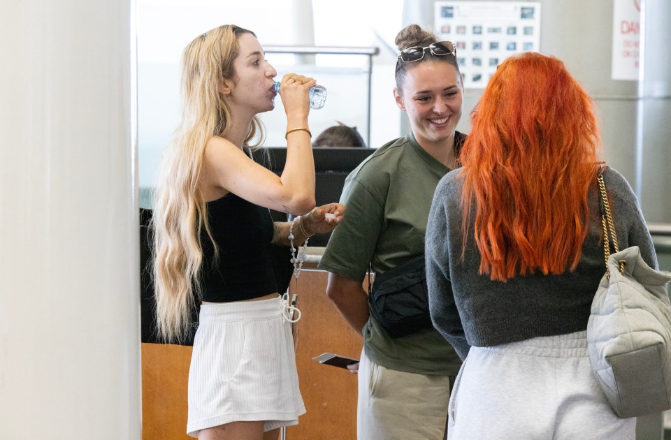 She was seen chugging water while standing beside her girlfriend Ella Rutherford