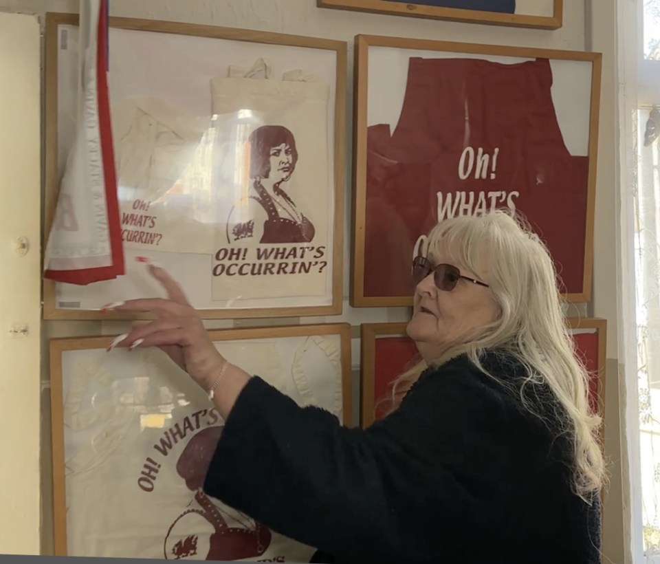 Woman displaying Gavin & Stacey memorabilia.