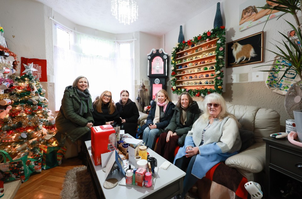 Glenda Kenyon, owner of Stacey's house from Gavin & Stacey, sits on the show's set sofa with visitors.