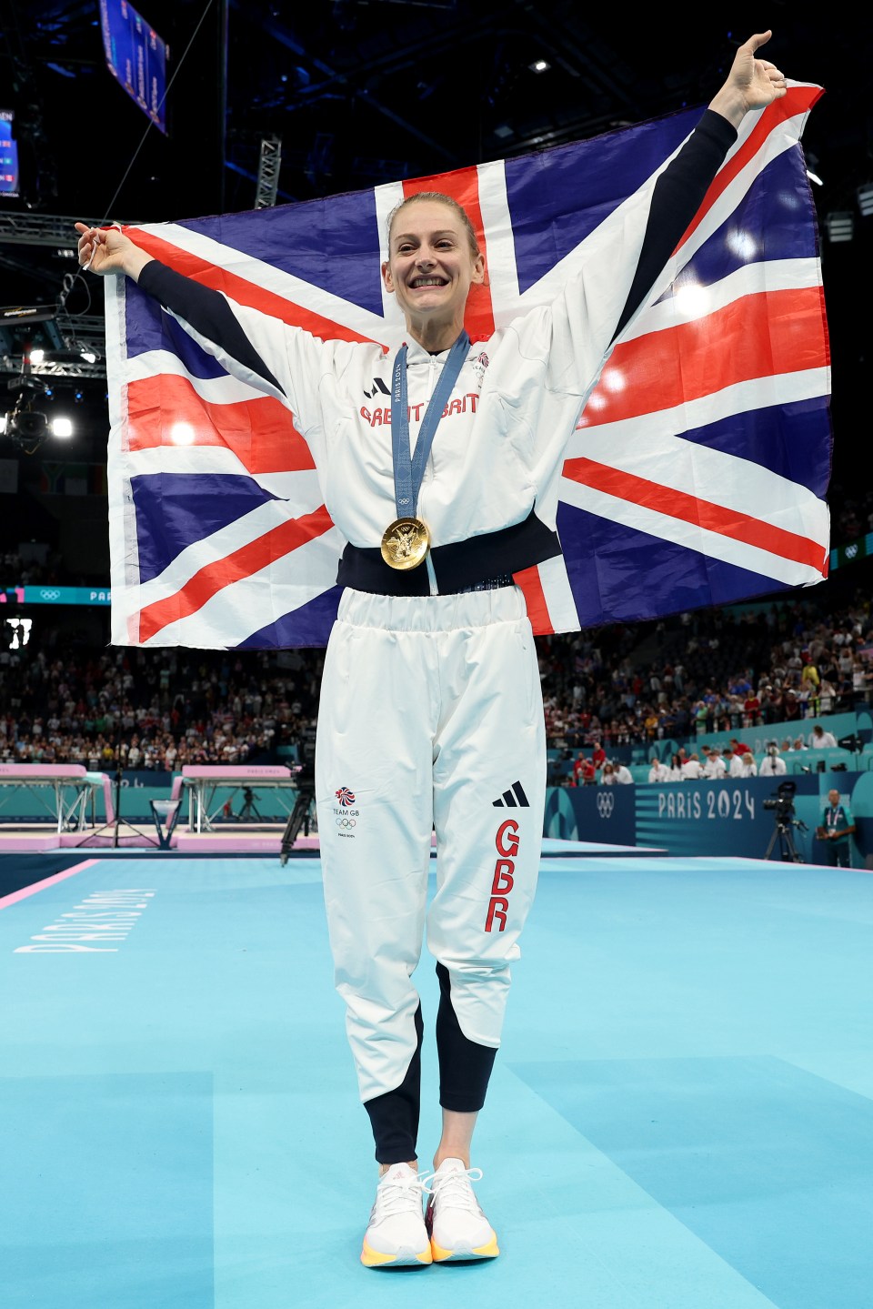 Bryony Page, a British Olympic gold medalist in trampoline gymnastics, celebrates with the Union Jack.