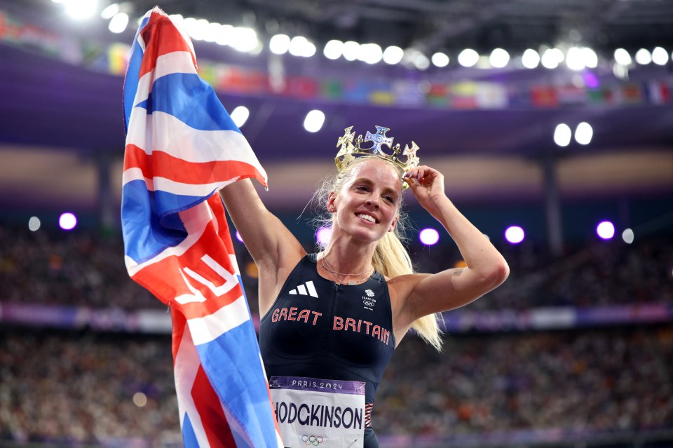 Keely Hodgkinson, gold medalist in the women's 800m, celebrates with a crown and British flag.