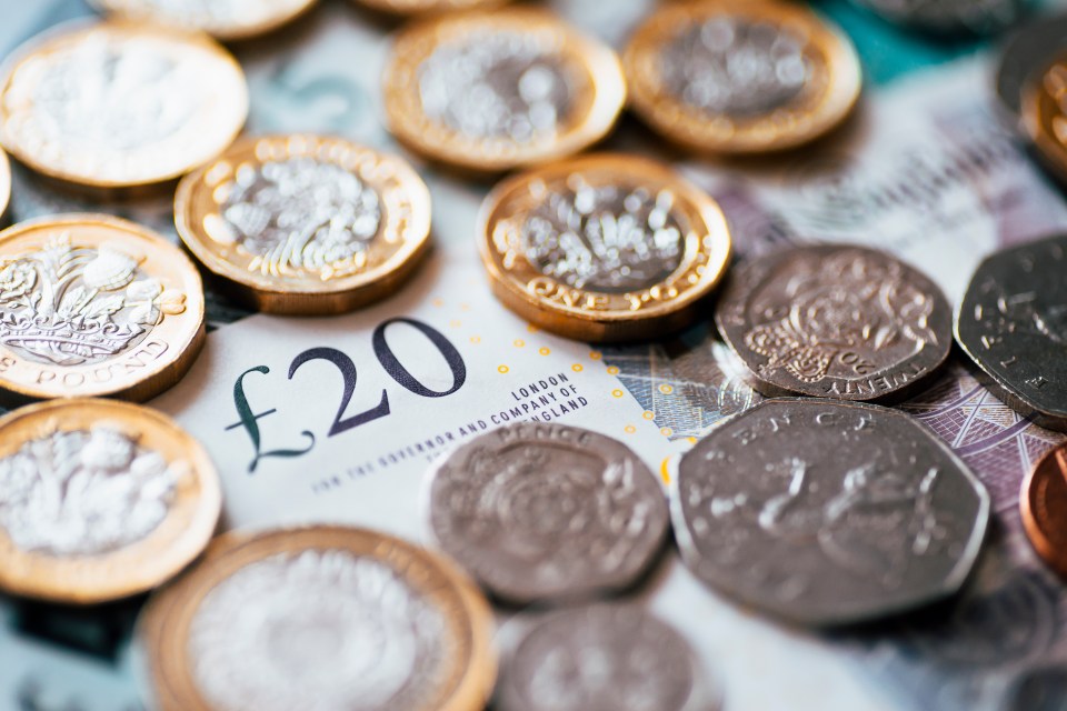 British pound coins and a twenty pound note.