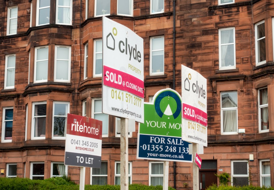 Real estate signs outside a residential building.