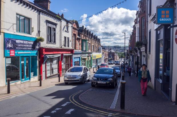 Shops and pedestrians on Senhouse Street in Maryport, Cumbria.