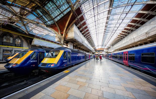 Paddington Station platform with several trains.