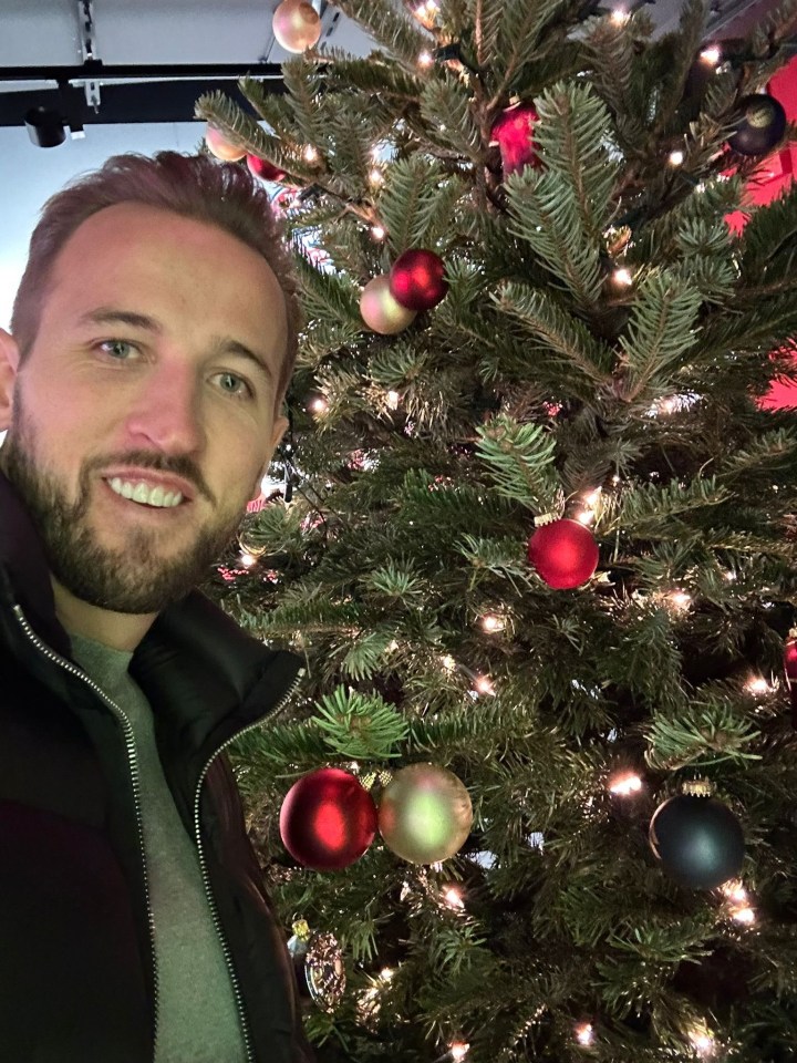 Harry Kane by a decorated Christmas tree.