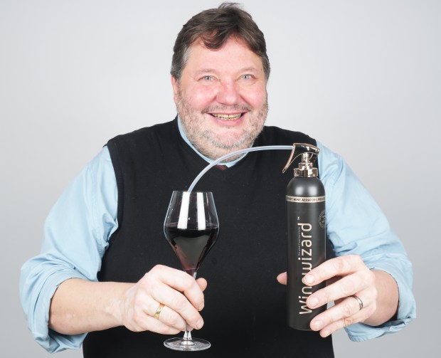 Man aerating wine with a Wine Wizard.