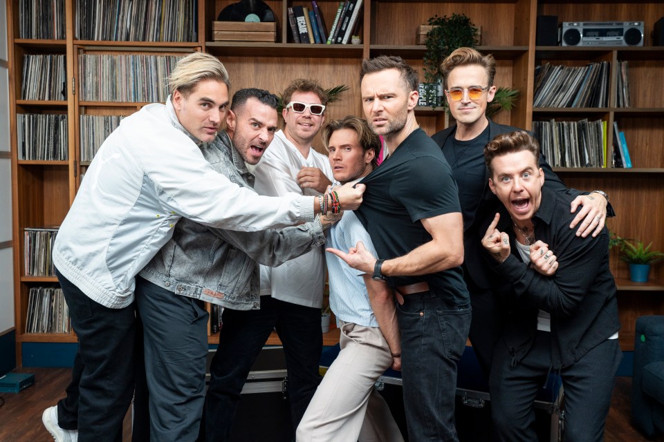 McFly and Busted posing together.