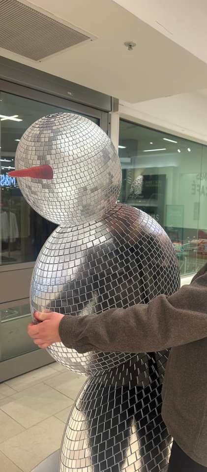 Disco ball snowman in a shopping mall.