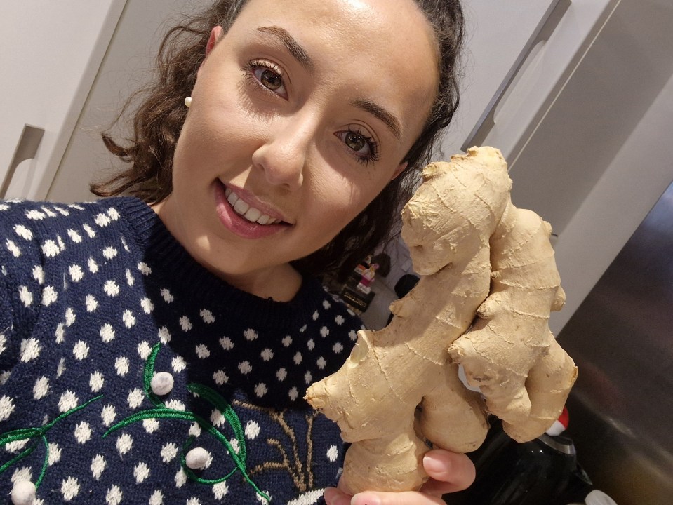 Woman holding a large piece of ginger.