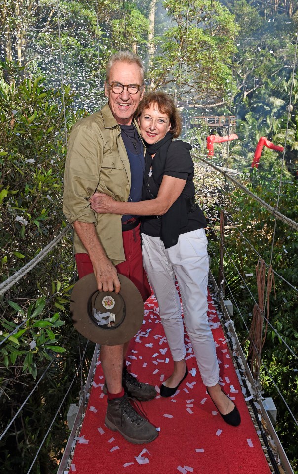 Larry Lamb and a woman embracing on a bridge, confetti falling around them.