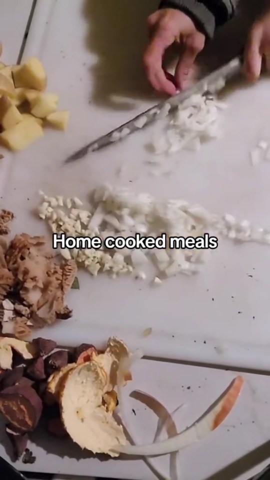 A person chopping vegetables for a home-cooked meal.