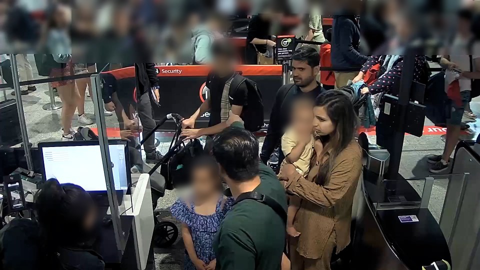 Blurred CCTV image of Sara Sharif's family at Heathrow Airport passport control.