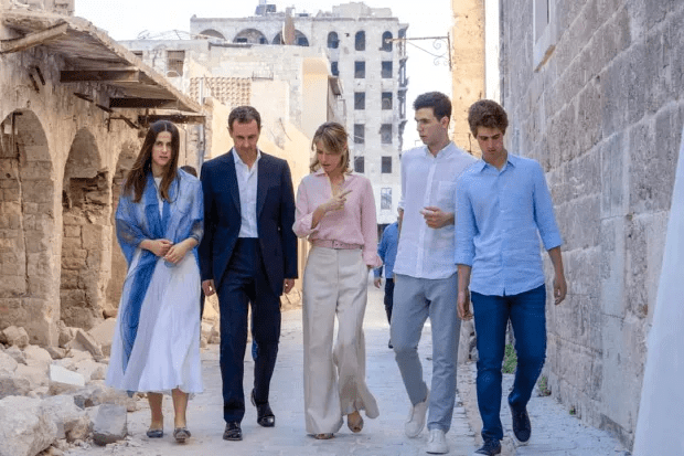 Bashar al-Assad (C-L) and his wife Asma al-Assad (C) walking with their children, Hafez (2nd-R), Karim (R) and Zein (L); they have all been granted political asylum in Russia