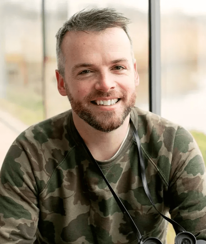 Portrait of a smiling man wearing camouflage.