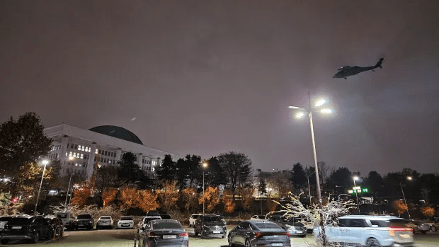 A helicopter is seen flying around the National Assembly hall