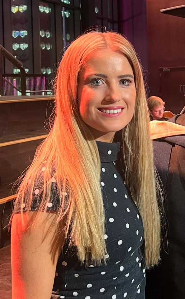 Woman with long blonde hair wearing a polka dot dress.