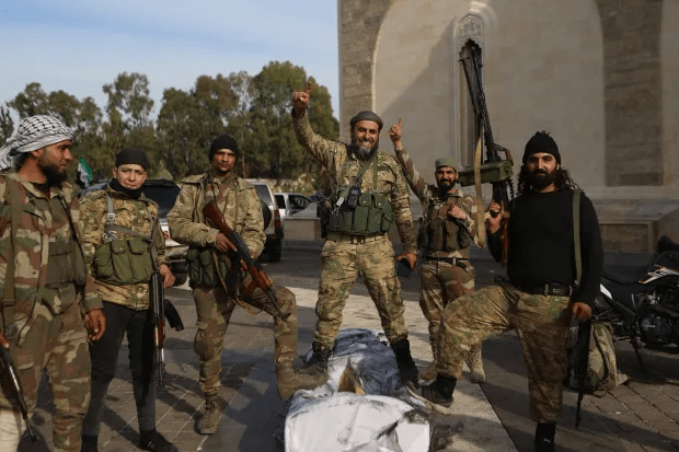 Armed fighters posing for a photo.