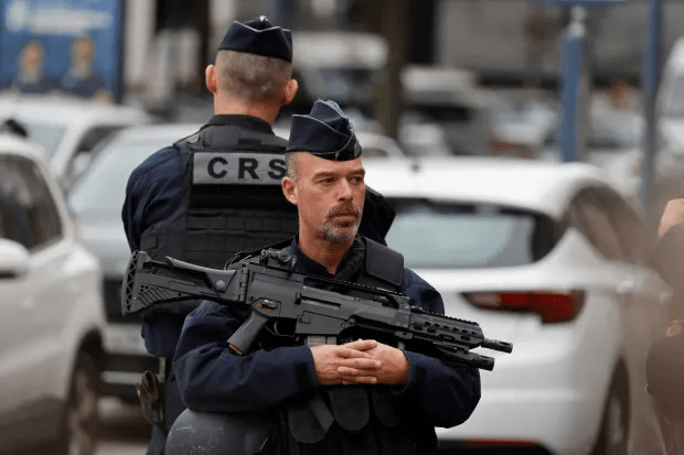 French CRS officer with rifle.