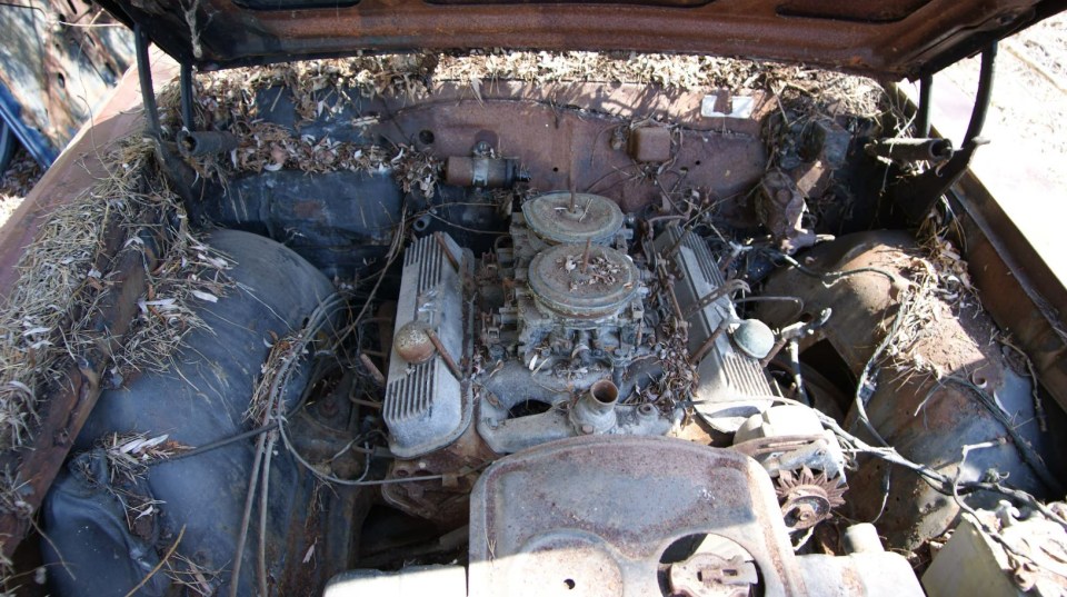 The engine inside one of the rusted vehicles