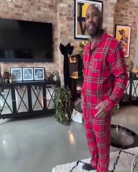 DJ Spoony in his home, wearing red plaid pajamas.