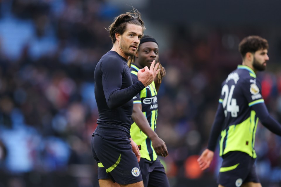 Jack Grealish of Manchester City gestures to Aston Villa fans, referencing his three league winner's medals.