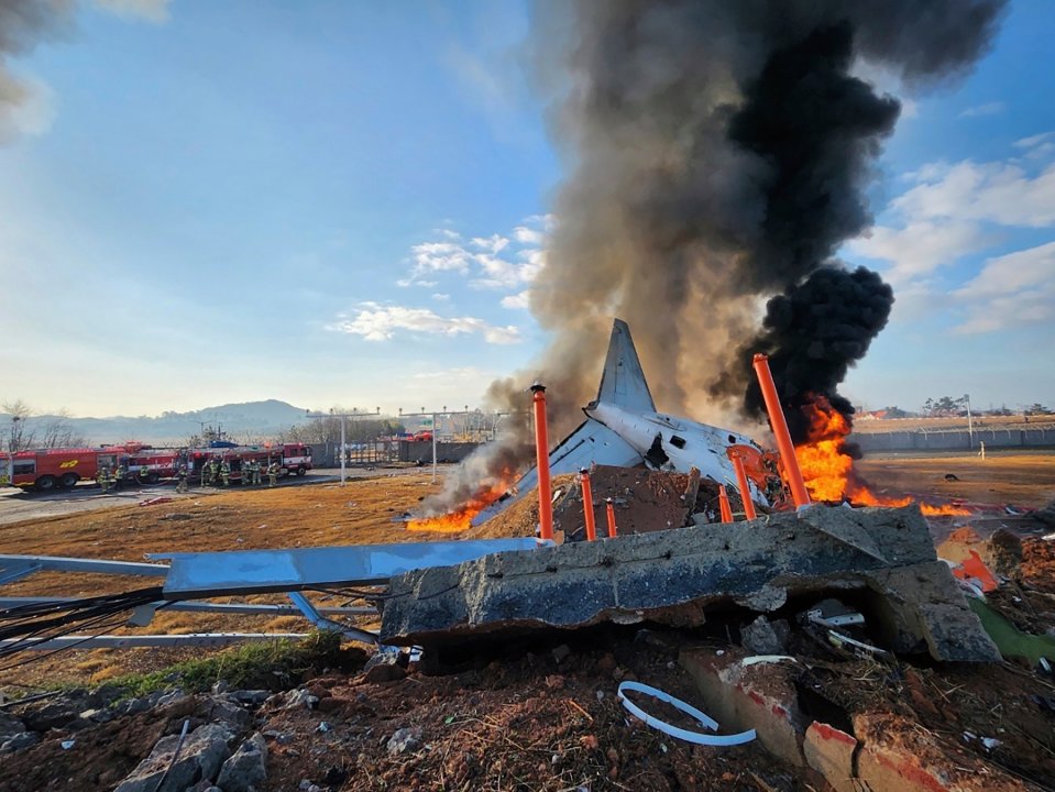 Burning wreckage of a Jeju Air plane that crash-landed at Muan International Airport.