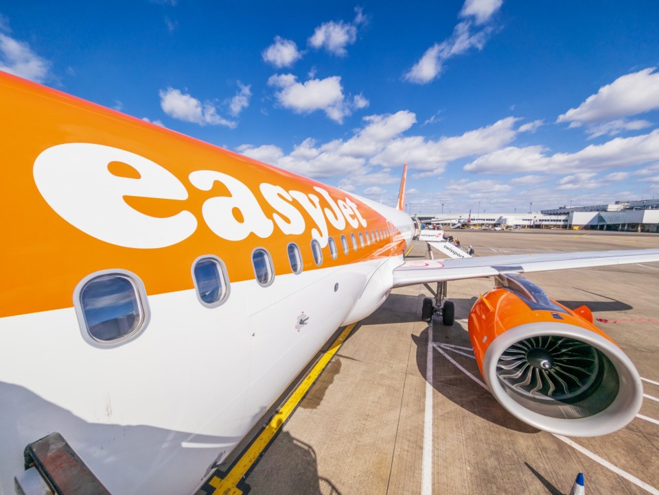 A view of the plane and passengers in the distance, taken from the top of the front stars while boarding an Easyjet flight from Glasgow, Scotland.