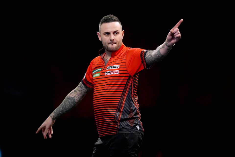 Joe Cullen celebrating during a darts match.