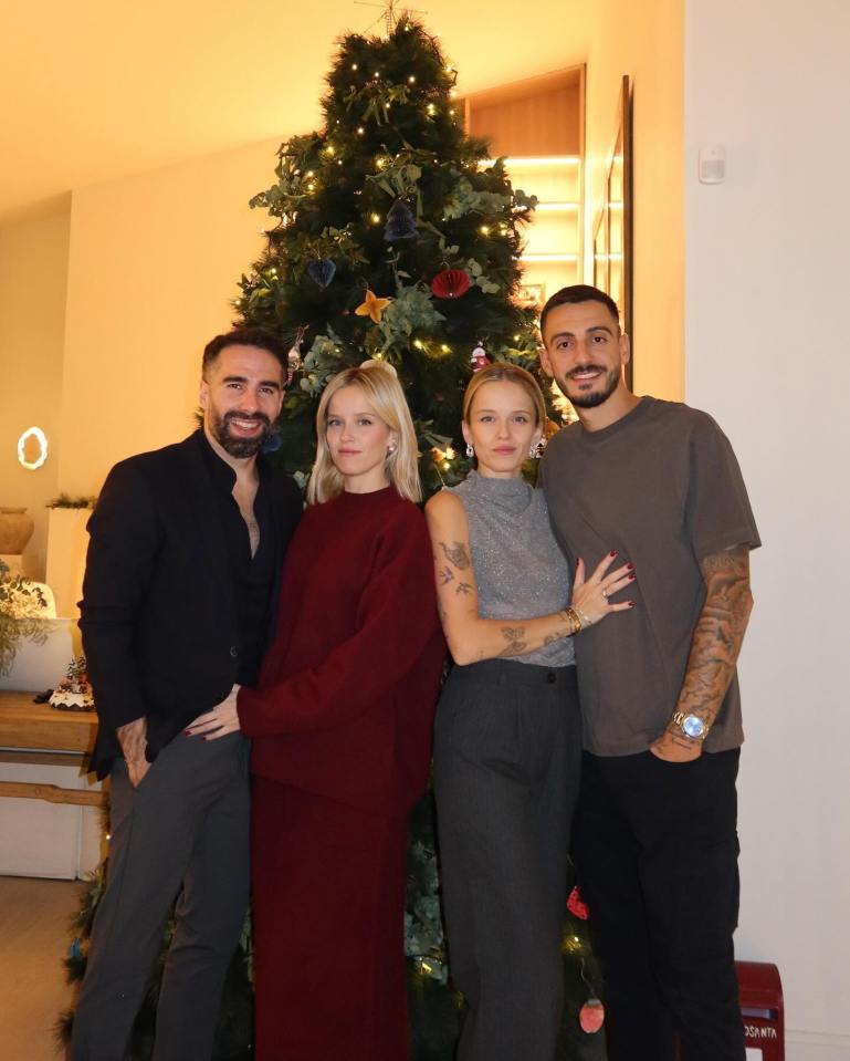 Joselu and Dani Carvajal with partners at a Christmas gathering.