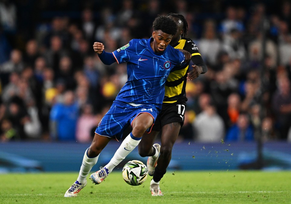 Josh-Kofi Acheampong of Chelsea is challenged by Katia Kouyate of Barrow during a Carabao Cup match.