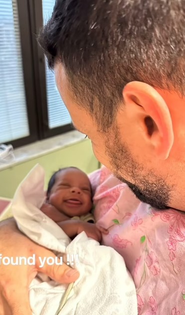 Cody cuddled the newborn after feeding him