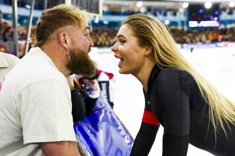 Jutte Leerdam receives congratulations after winning a speed skating championship.