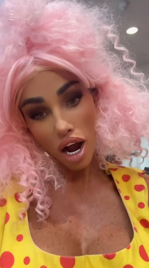 Katie Price wearing a bright pink wig and yellow polka dot dress.