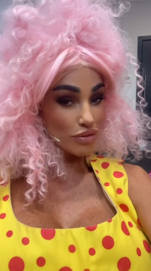 Katie Price wearing a pink wig and yellow polka dot dress.