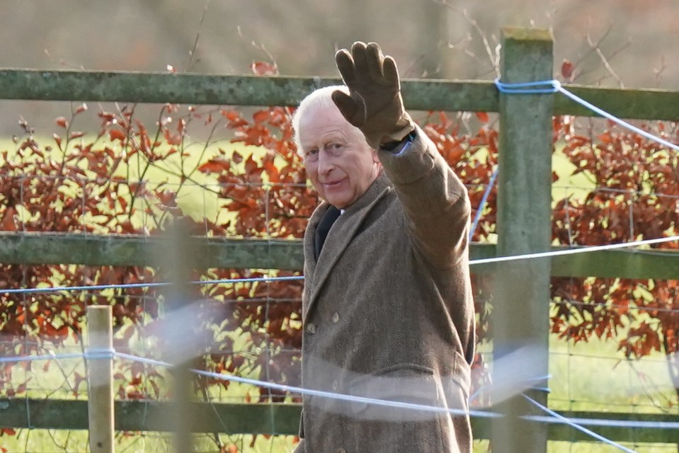 King Charles III waves to well-wishers.