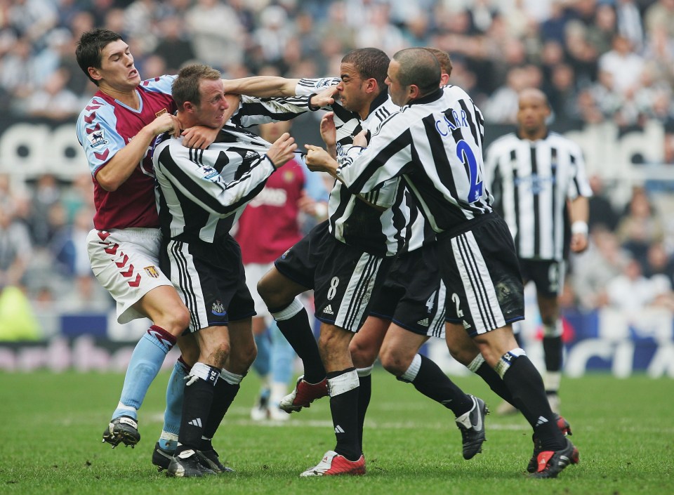 Lee Bowyer and Kieron Dyer have to be held back by players after a furious fight