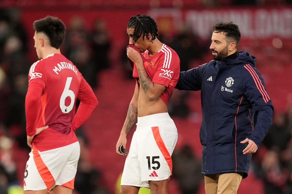 Manchester United players look dejected after a loss at Old Trafford.