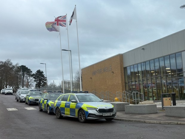 Police cars outside HMP Five Wells prison following a murder.