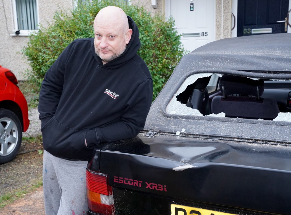 Shaun Watts with his Ford XR 3, which had a tree fall on it