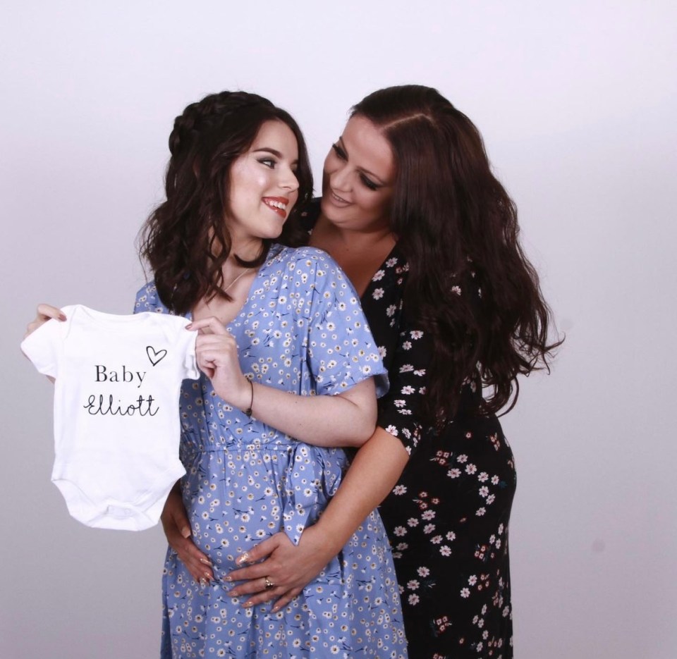 Pregnant woman and her mother holding a baby bodysuit that says "Baby Elliott".