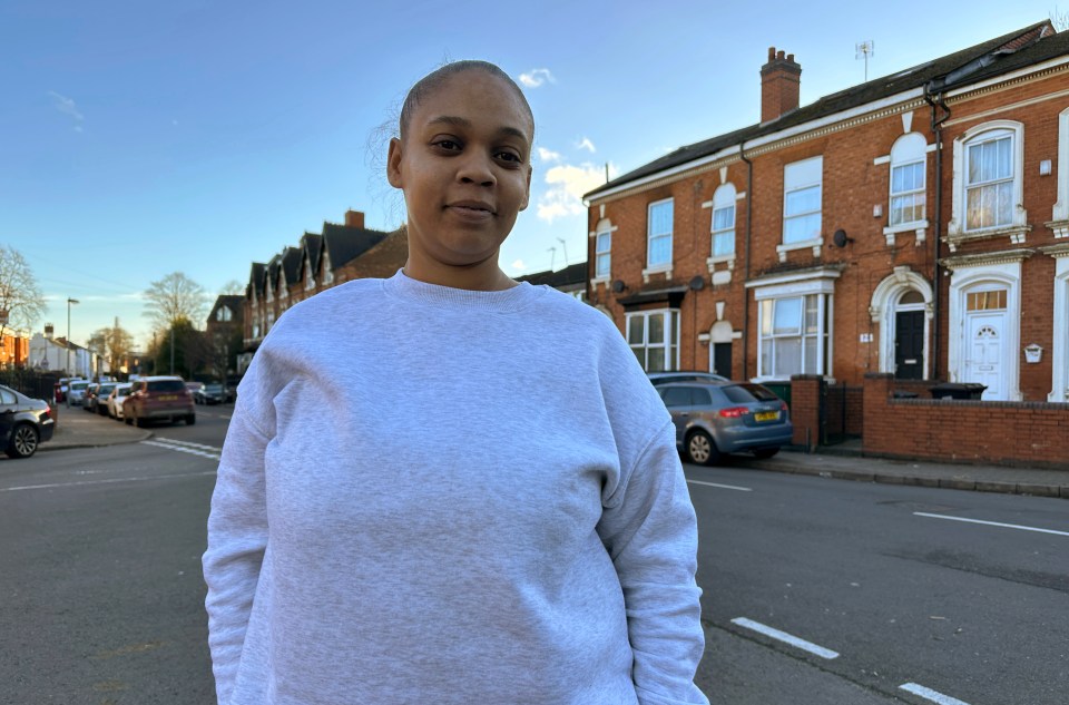 Hayley West, a Birmingham resident, stands on a street.