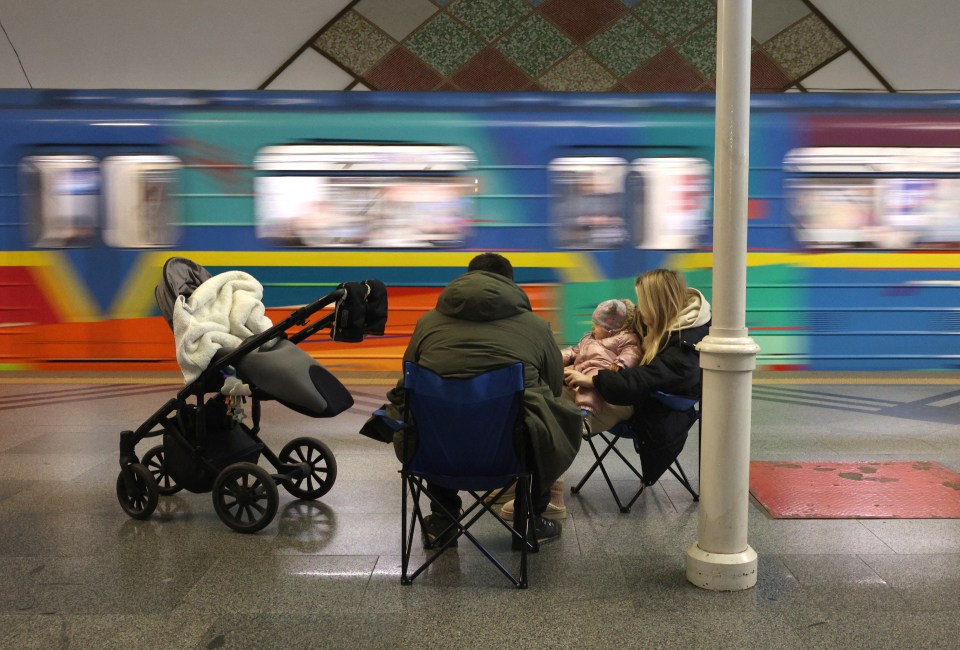 Family taking shelter in a Kyiv metro station during an air raid.