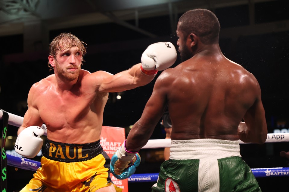 Logan Paul punches Floyd Mayweather in an exhibition boxing match.