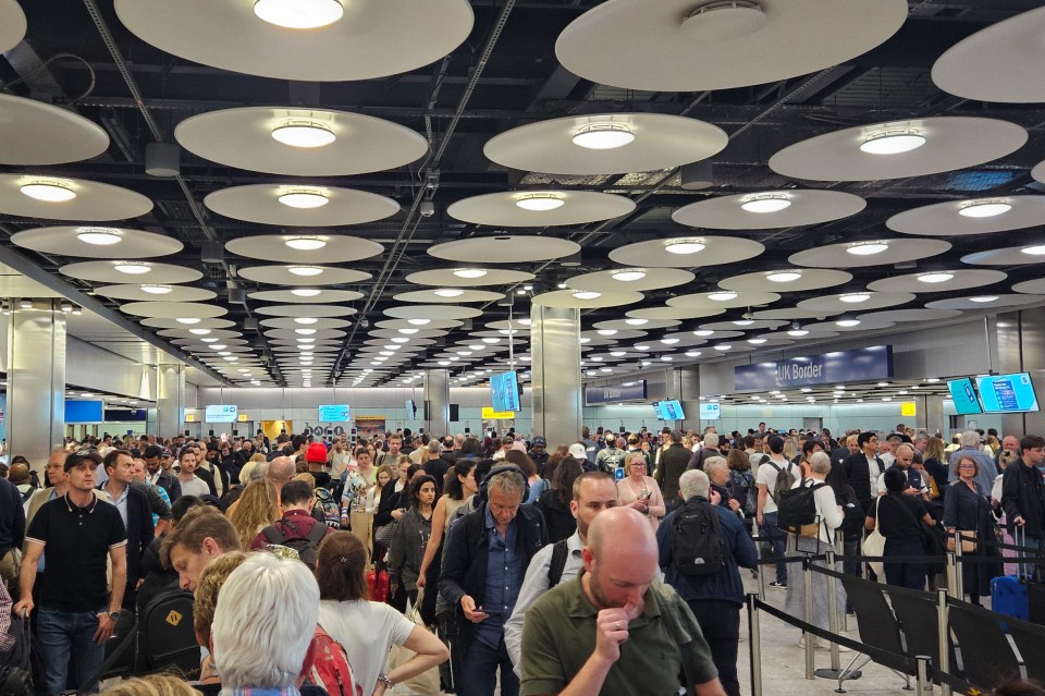 Long queues at a UK border checkpoint in London Heathrow Airport due to an electronic gate system malfunction.