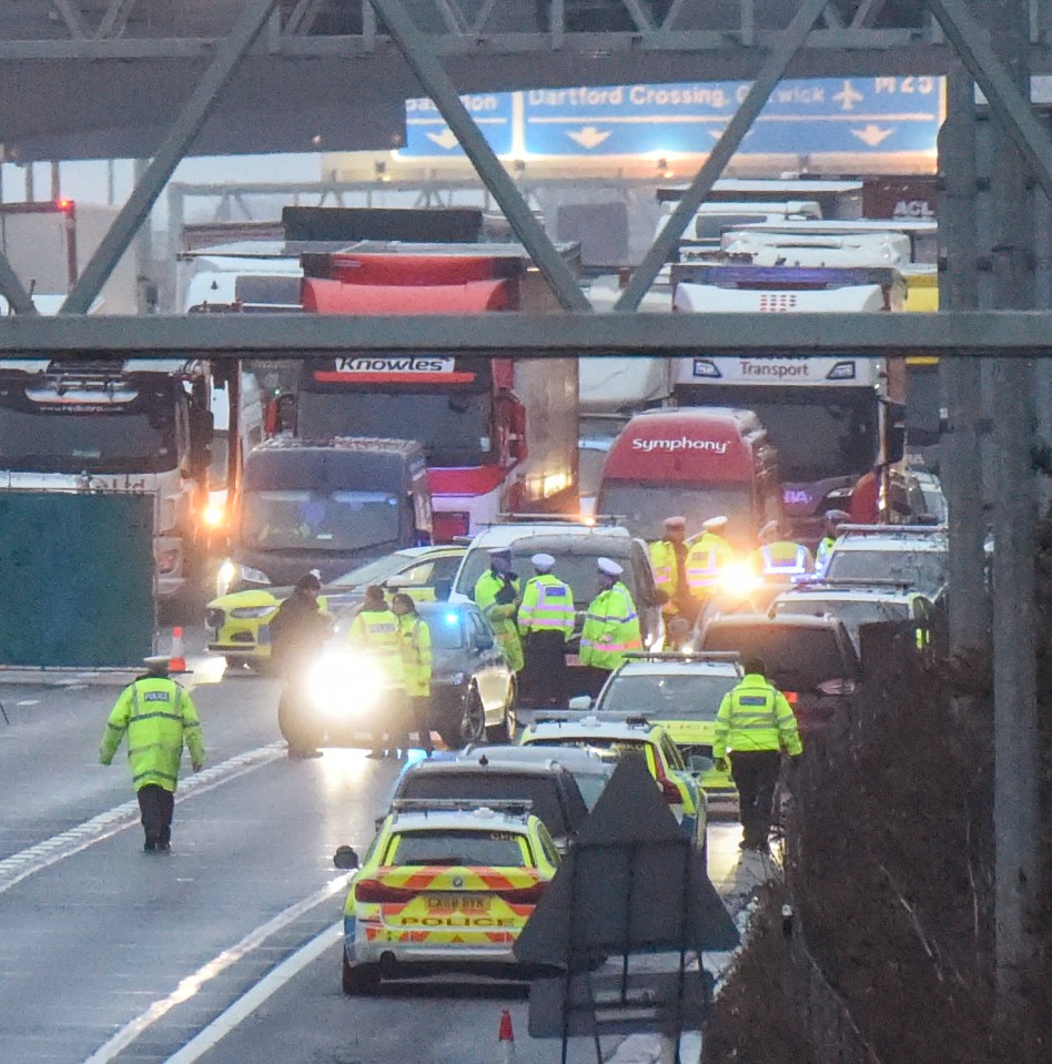 Police officers at the scene of a fatal M25 motorway accident.