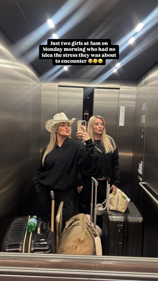 Two women with luggage in an elevator.